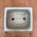 Top view showing 2 drainage holes and 4 wire holes.