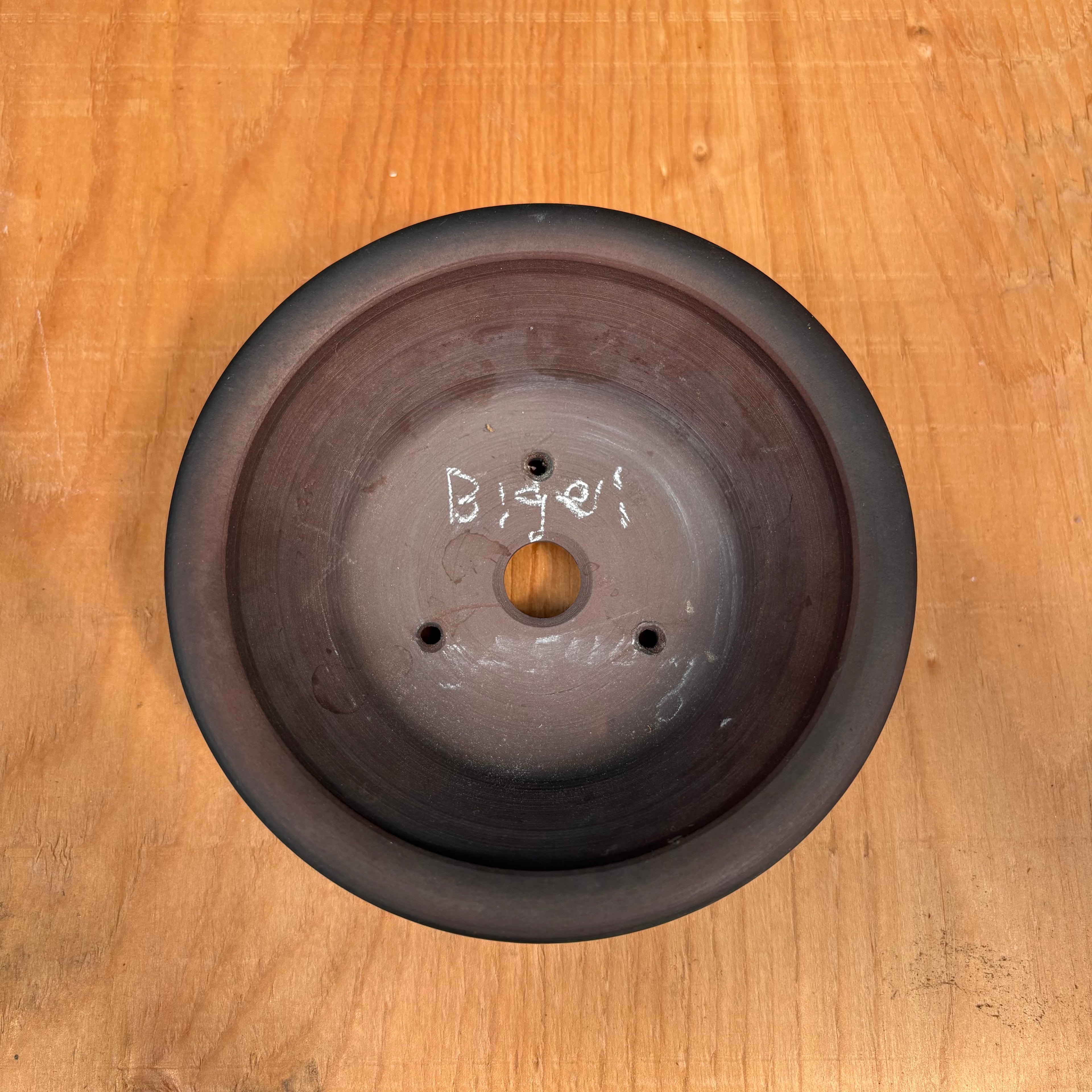 drainage hole and three wire holes.  round tokoname bonsai pot