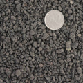 Close up particle size of the porous surface of black lava, for bonsai soil structure, drainage and aeration.